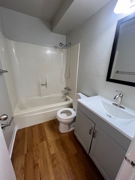 Renovated bathroom with a new vanity, framed mirror and tub-shower