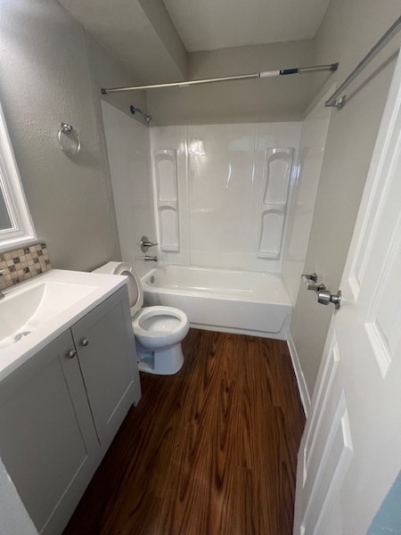 Updated bathroom with grey vanity, tile backsplash and tub-shower