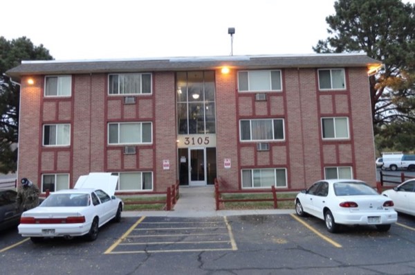 Main entrance of the brick apartment building at dusk