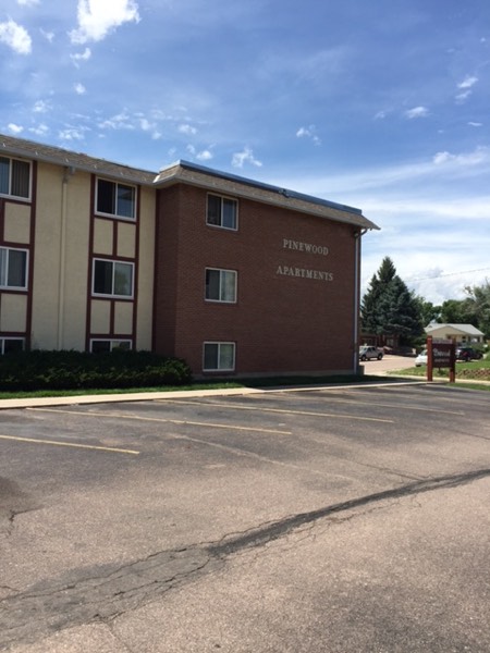 Side elevation of Pinewood Apartments with lettering on the brick