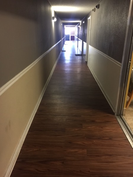 Clean interior hallway with wood-look plank flooring