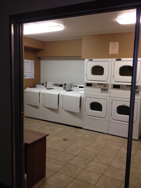 On-site laundry room with multiple washers and stacked dryers