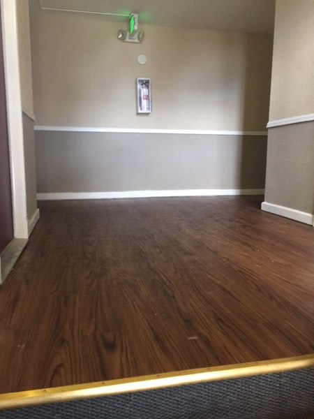 Living area with wood plank flooring and two-tone painted walls
